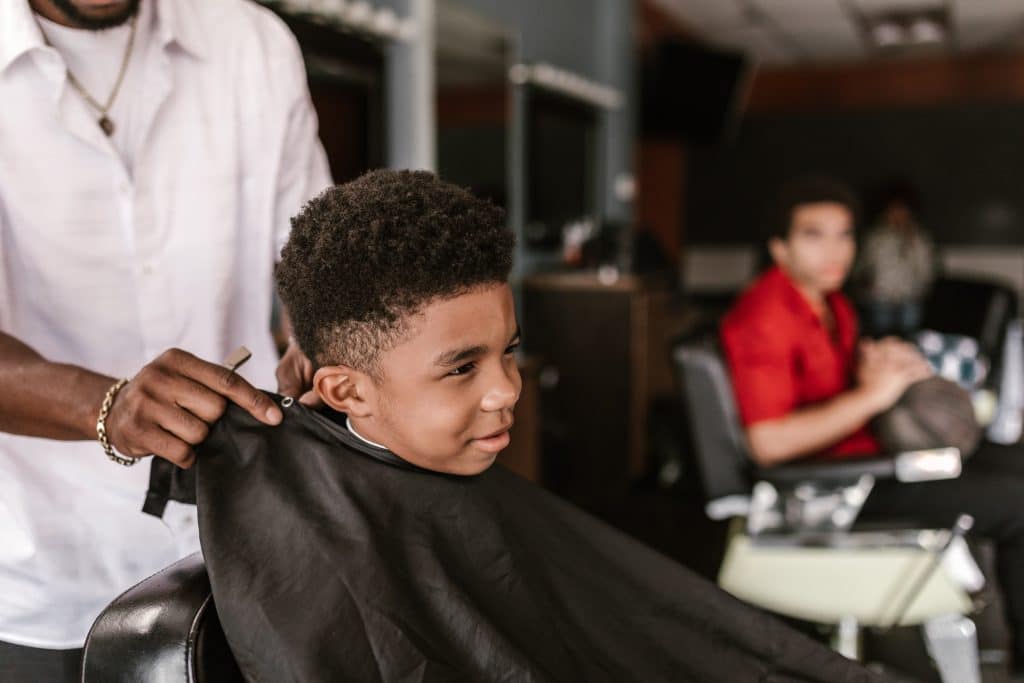 a young boy with autism getting his haircut