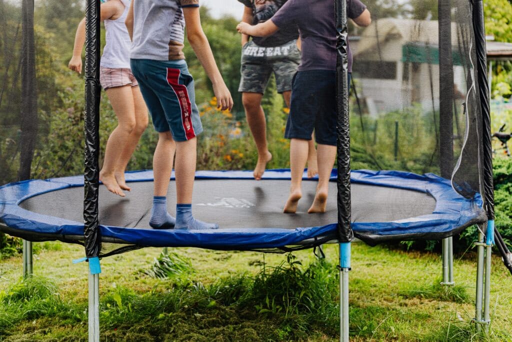 Four young boys enjoy their autism sensory toy by jumping on a trampoline. autism toys