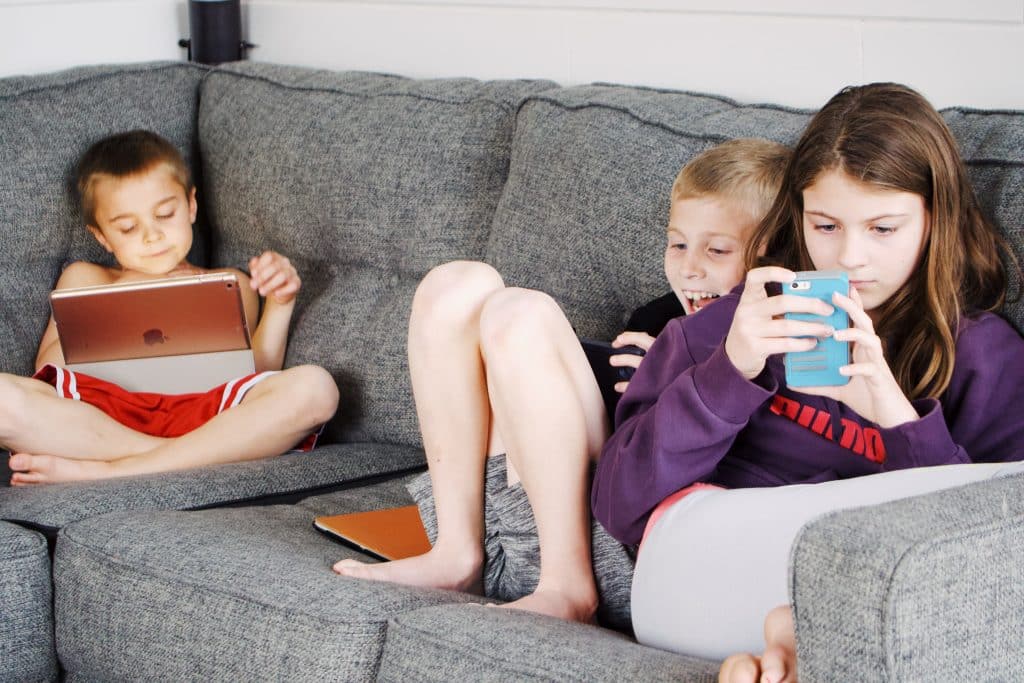 children with adhd playing apps on their devices, a time-sucking activity not realizing how much time is passing because of time blindness