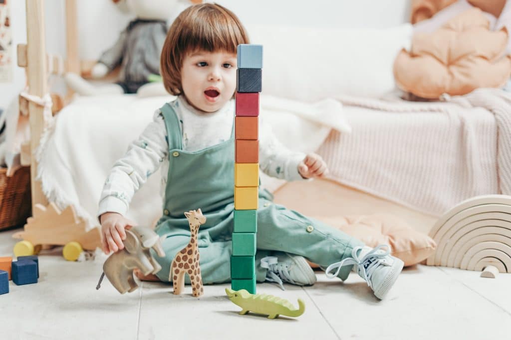 Autism sensory toys this image shows a little boy playing with different toys