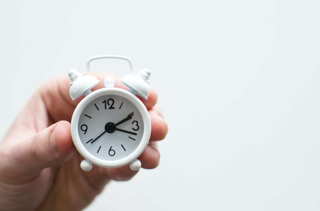 Timers for kids this image shows a hand holding a clock