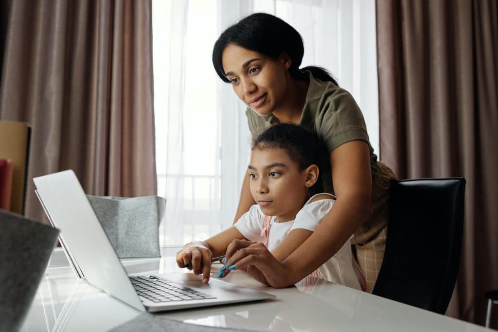 how to focus on homework. A child is getting help with focusing on her homework from a parent.