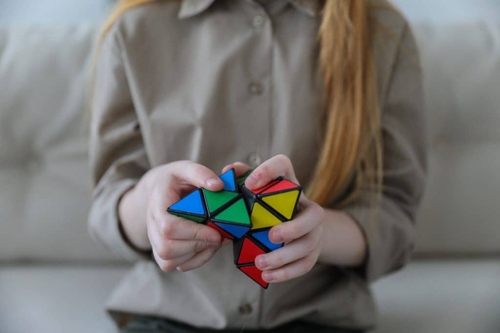 adhd calming toys. A child with adhd plays with a toy to calm her down.