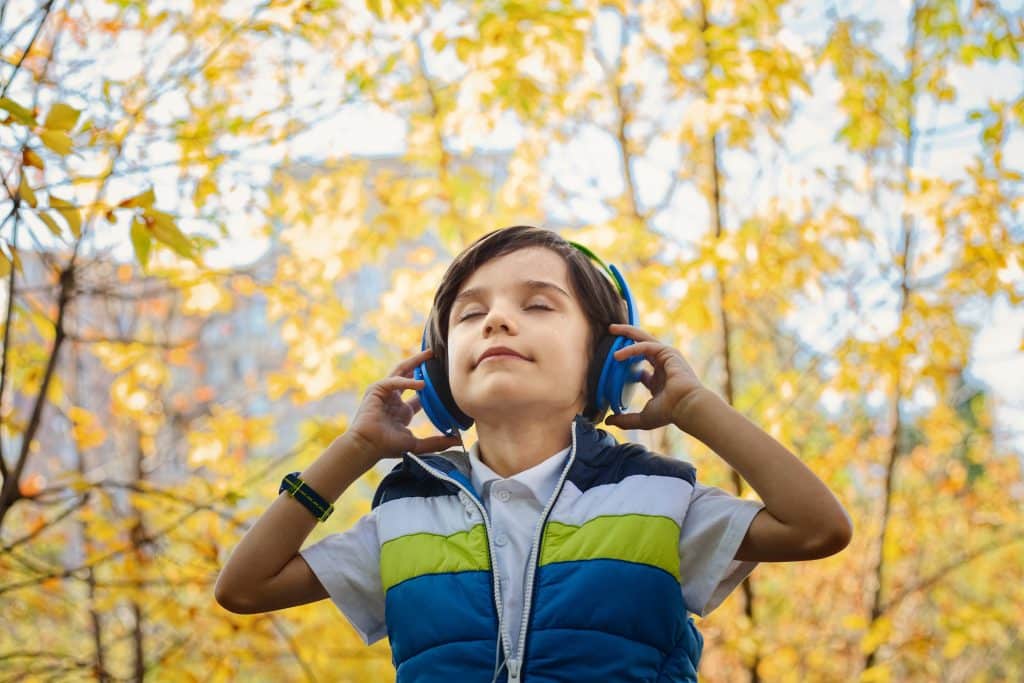 adhd calming toys. A young boy uses noise cancelling headphones to help calm himself.