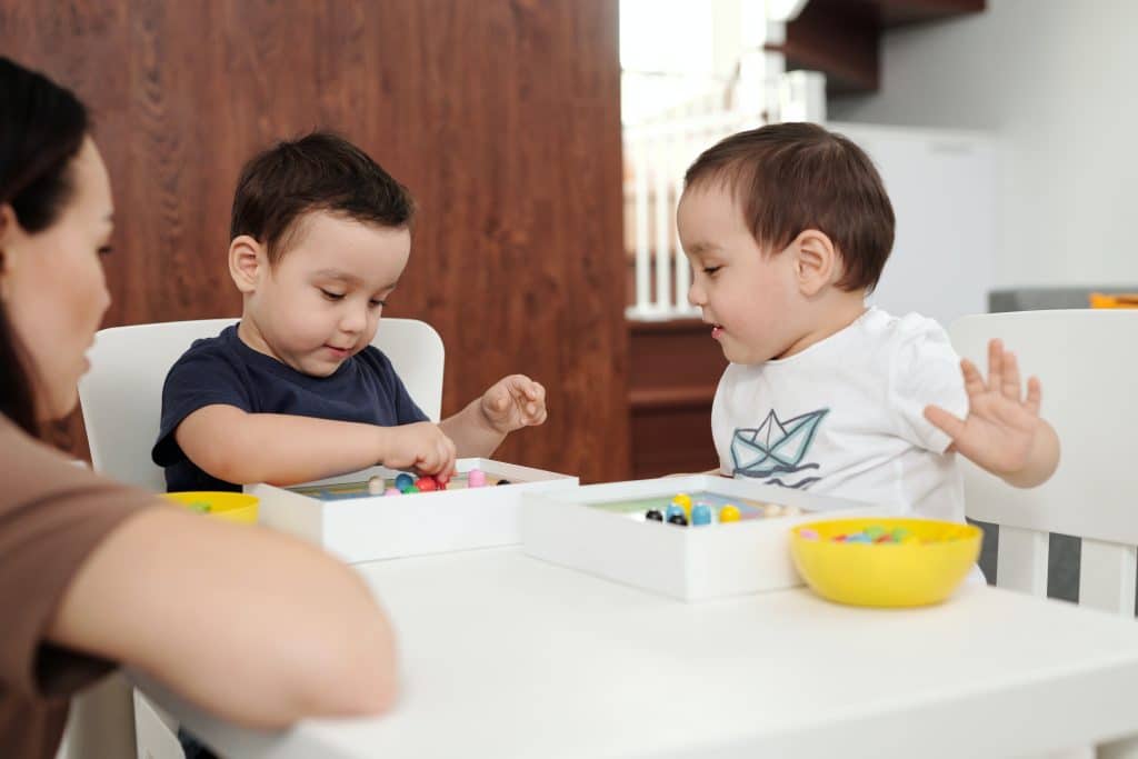 How to improve a child's memory? Two little boys sit at a table and play a game that improves memory.
