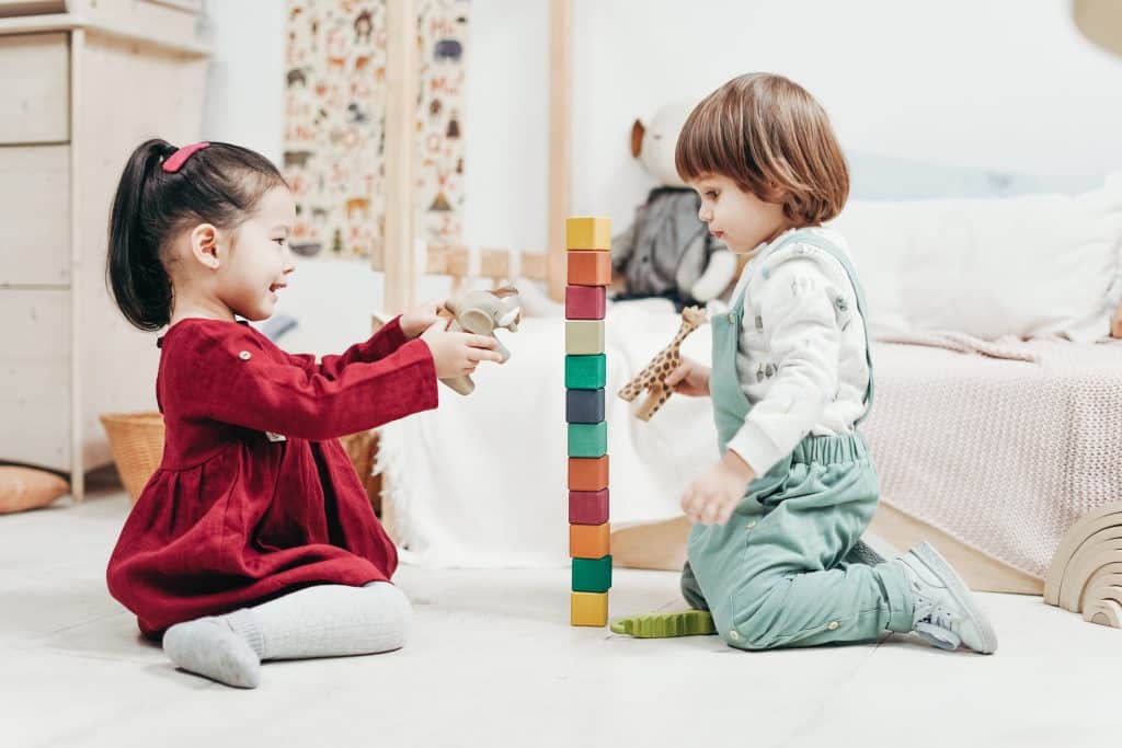 is adhd a form of autism little kids playing with blocks on floor