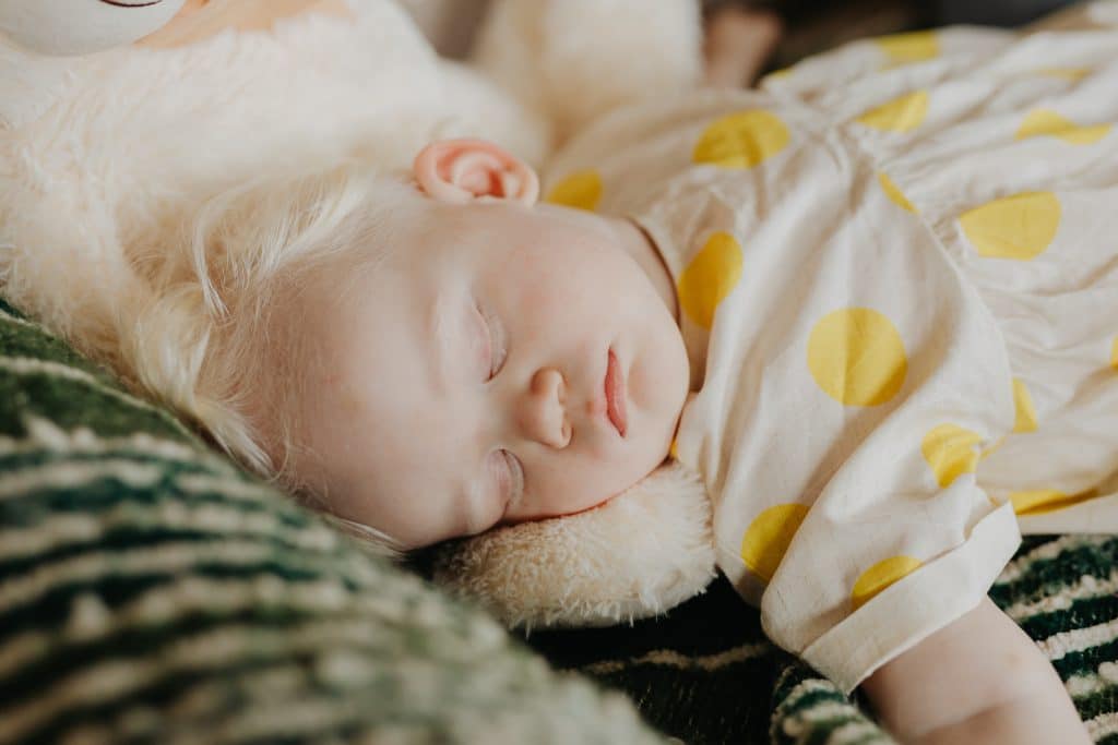 How much sleep do kids need by age? A toddler is sound asleep.