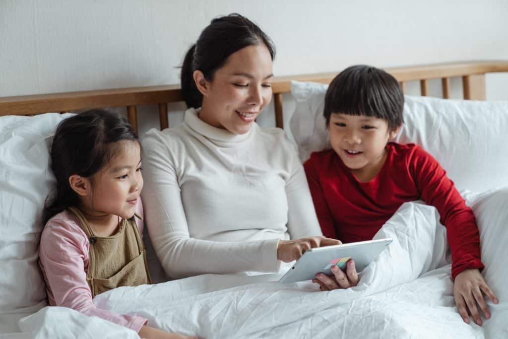 What Not To Say to a Child With ADHD? Two kids learn with their mom.
