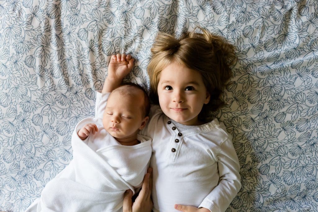 can babies have adhd. toddler girl laying with baby brother