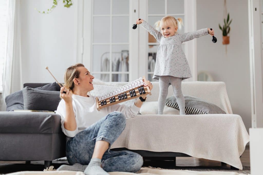 Do Adhd Kids Ever Catch Up? A mom and kid play music.