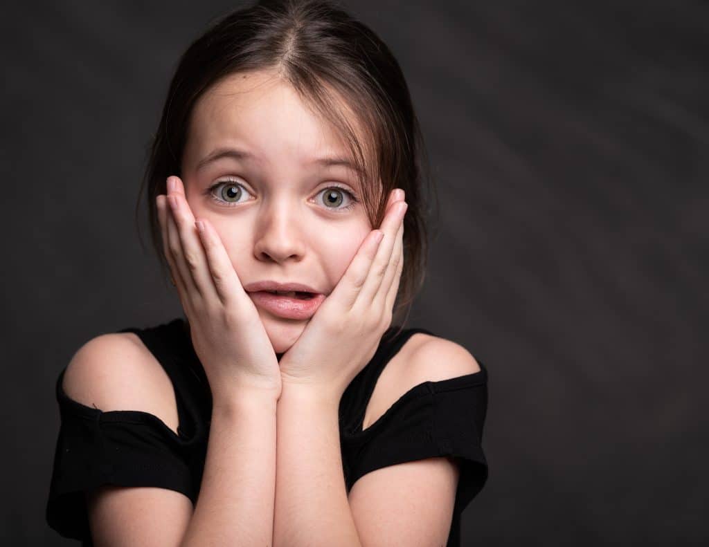 how does yelling affect adhd little girl upset with hands on face