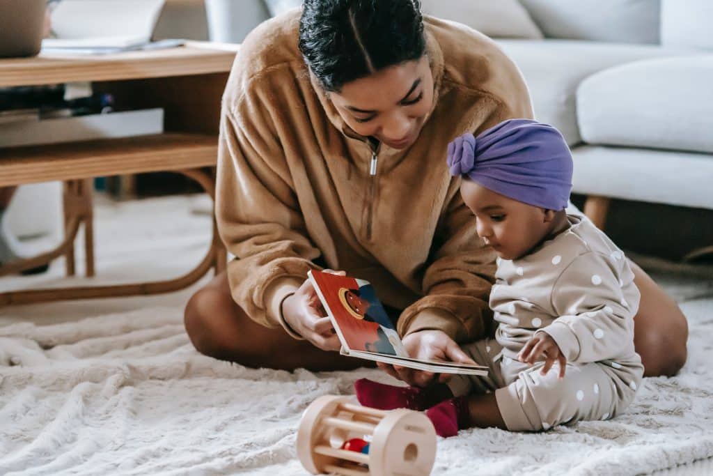 physical development in infancy little baby stretching  little baby looking at book with mother