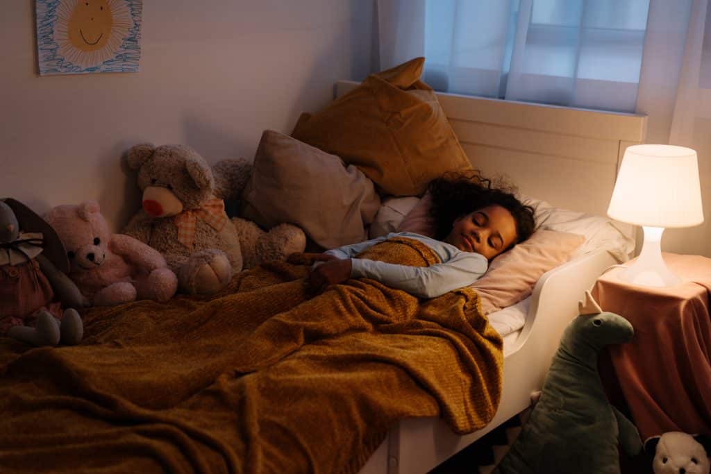 ADHD sleep issues. a kid in bed is sleeping. staying awake at night adhd