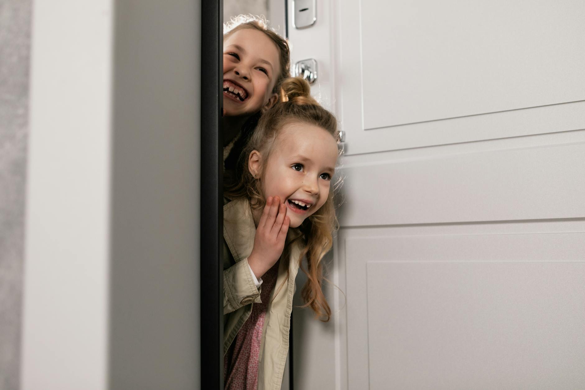 answer the door. girls standing beside white door