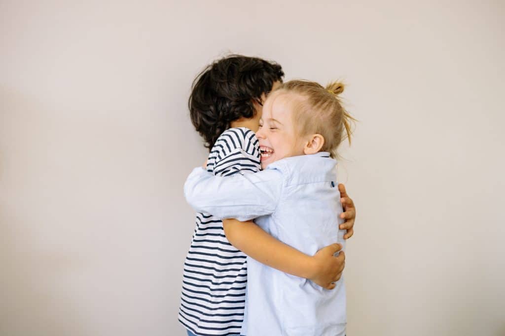 free printable kindness worksheets pdf. two kids are showing kindness by hugging one another.