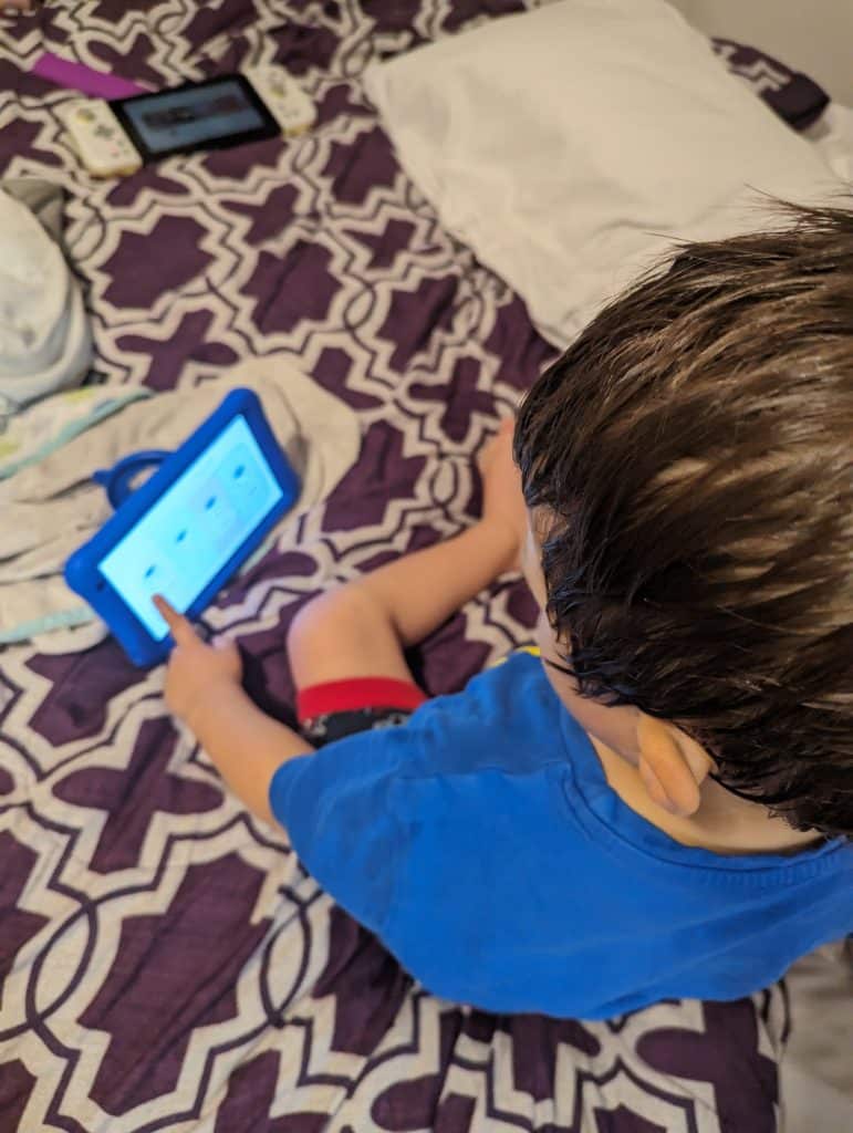 best learning apps for toddlers. a boy is seen using the Goally device to learn.