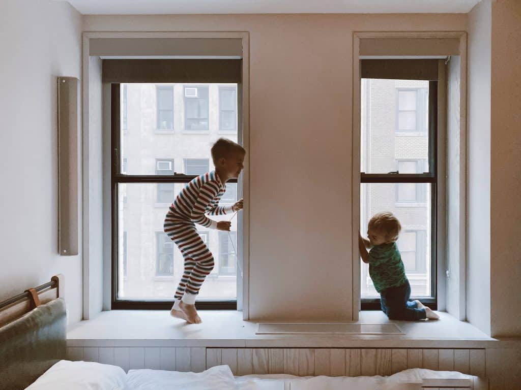 understanding adhd. Two kids are playing together on the window sill.