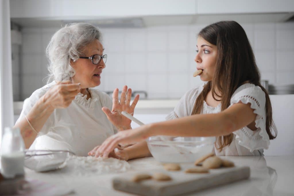 adhd therapy activities. a girl is baking with her grandma.