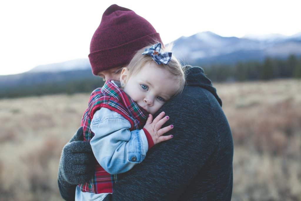how to apologize. A girl is giving her parent a hug and learning how to apologize.