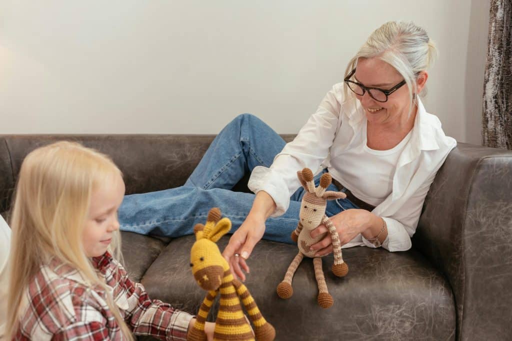 negative emotions list. A mom is playing her child and teaching about emotions.