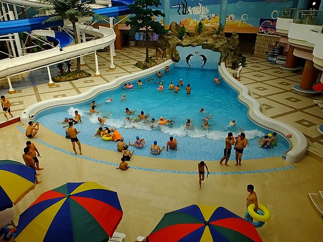 fun things to do in the summer. people are playing at the waterpark.