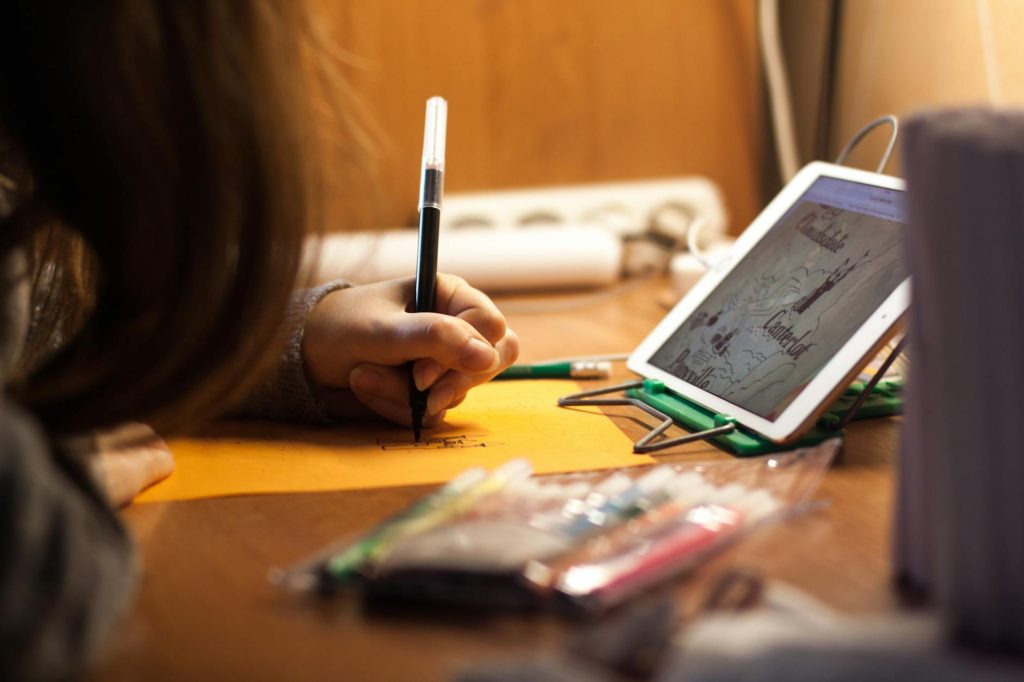 woman writing on orange paper