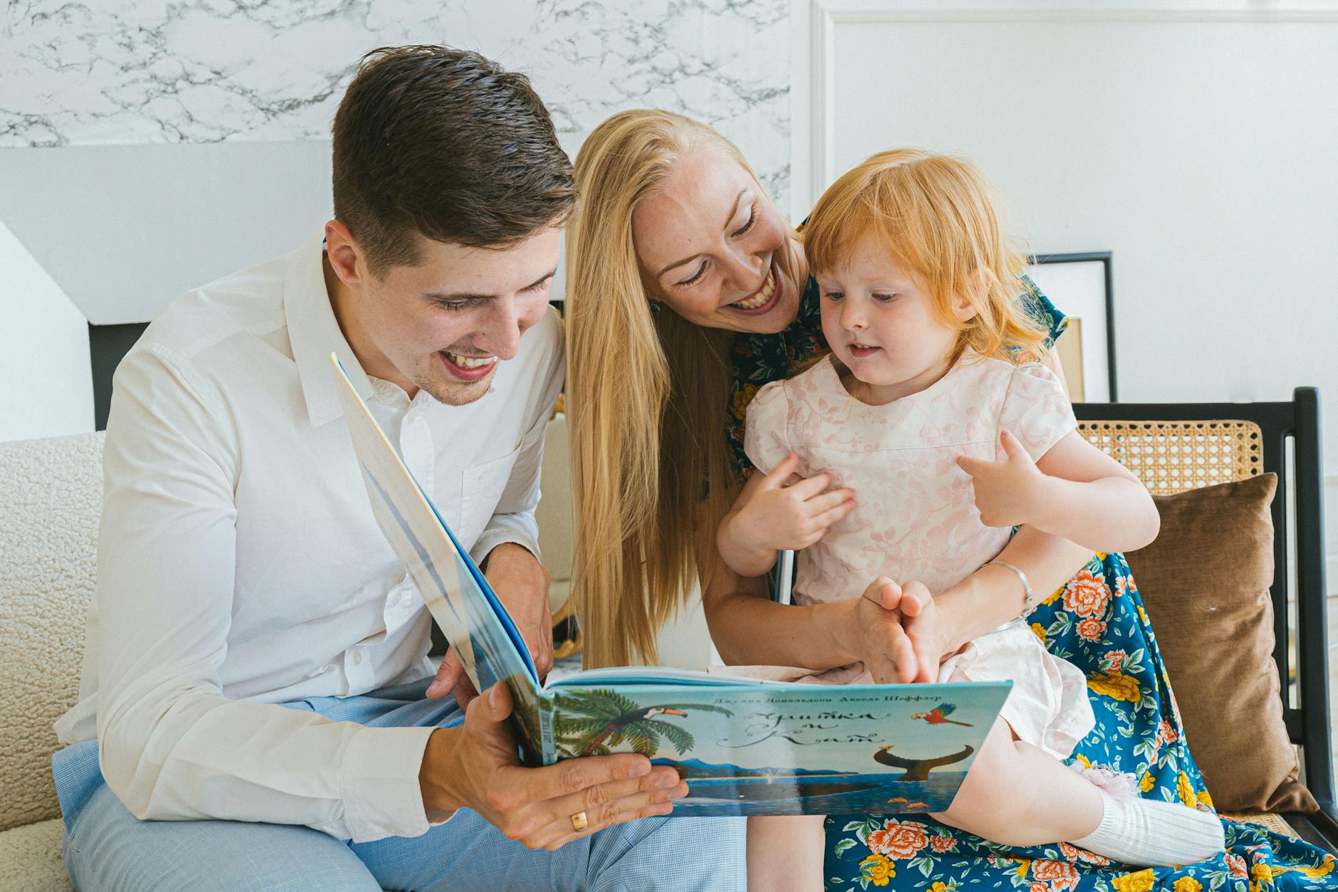 10 ways to improve memory. photo of a family reading a book together