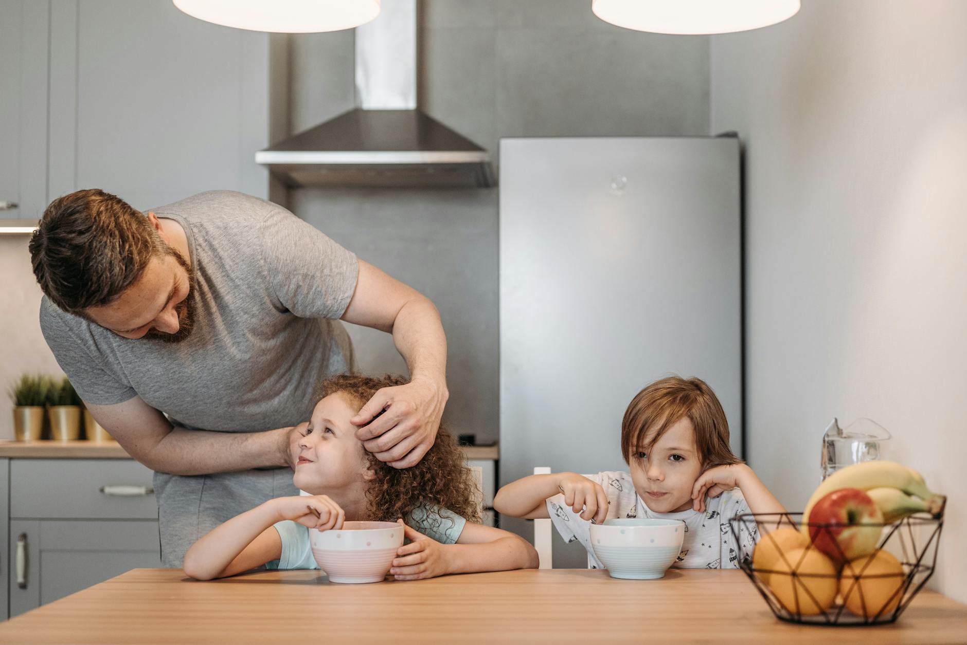 a man talking to his daughter while having breakfast